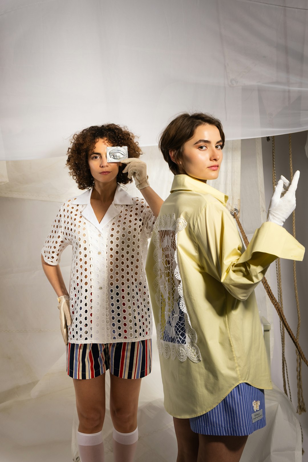 about-01 two-women-holding-condom-packets-one-covering-eye-qpmxycoiss8